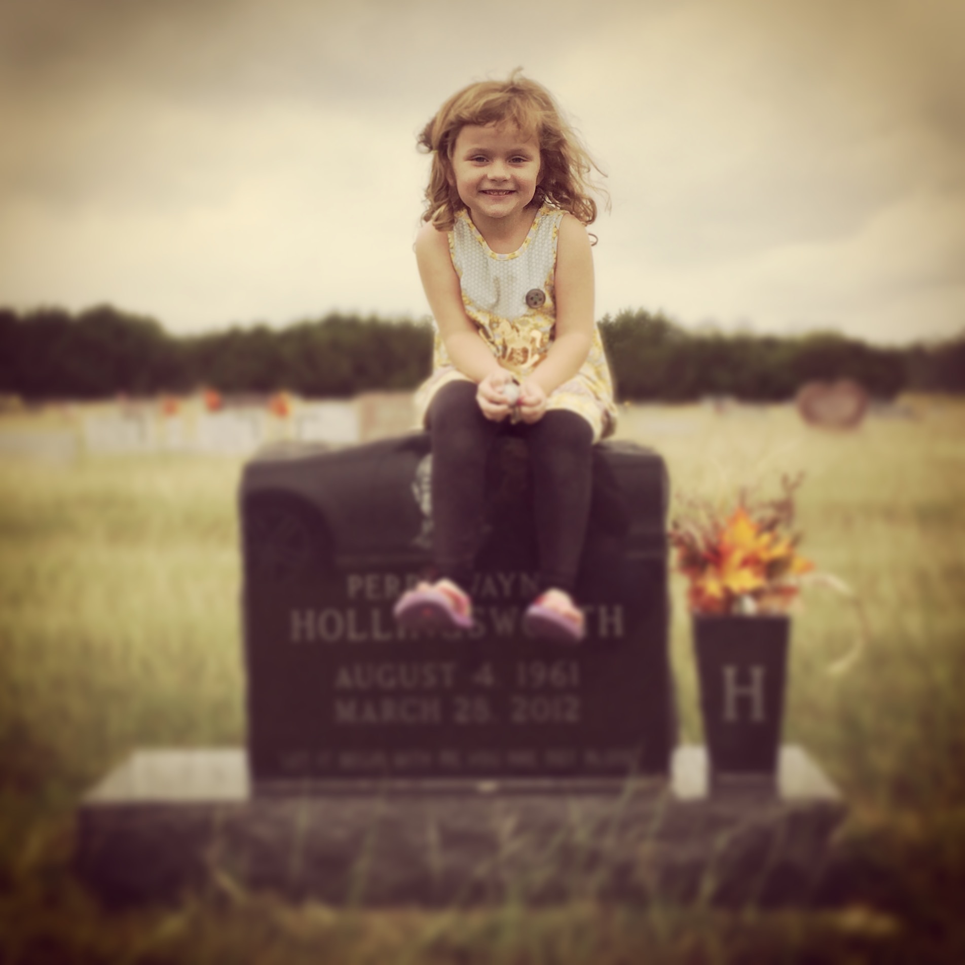 Perry Kate at her grandfather Perry Wayne Hollingsworth’s headstone in Clifton Cemetery