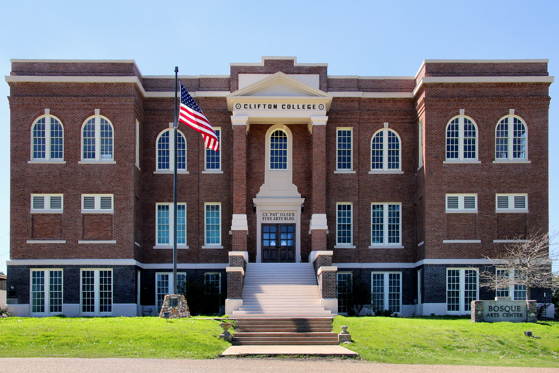 The brick façade and entrance steps of the historic Clifton College building, home of the Bosque Arts Center, photographed in 2015.