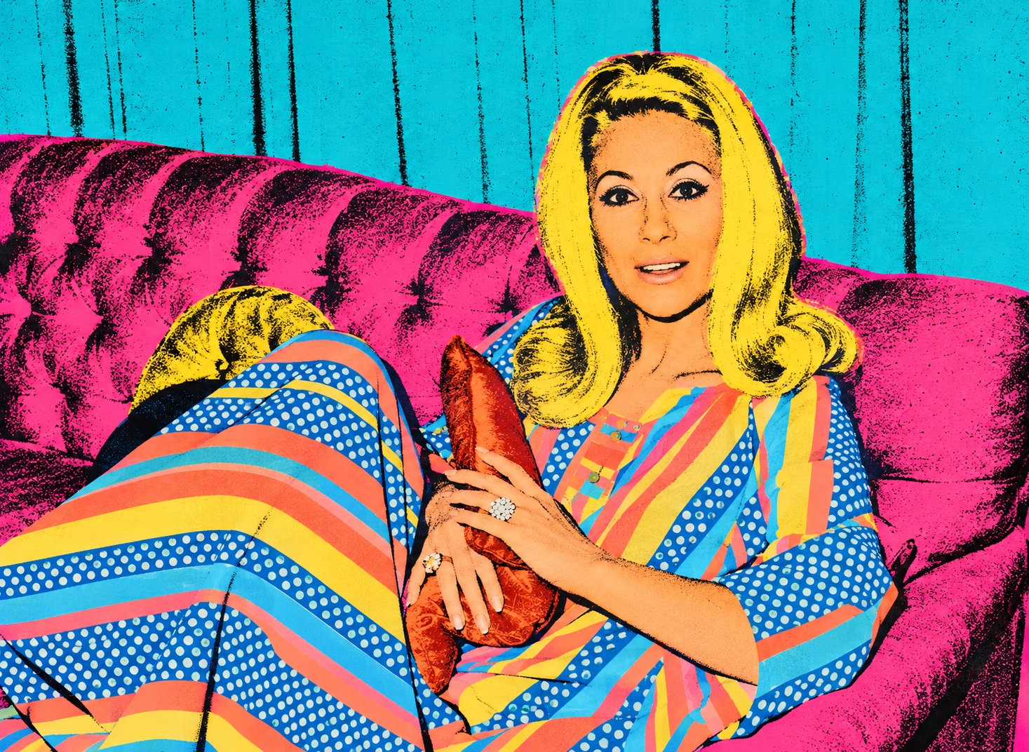 Pop-art portrait of Ivana Sue reclining on a vivid pink sofa against turquoise walls