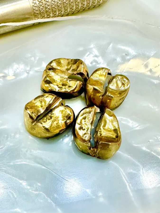 Four removed gold dental crowns